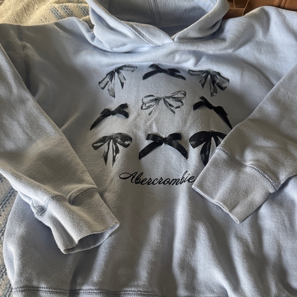 abercrombie kids Pale Blue Pullover Hoodie with Black Bow Detail. Size 11/12.